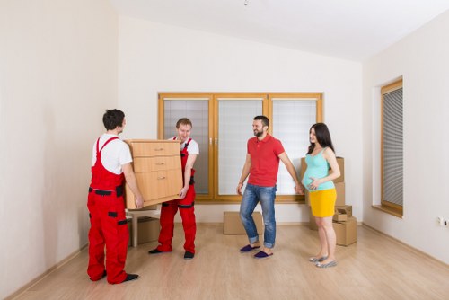 Household furniture and boxes being prepared for a removals van move
