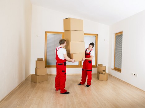 Packed moving boxes and protective wrapping ready for collection