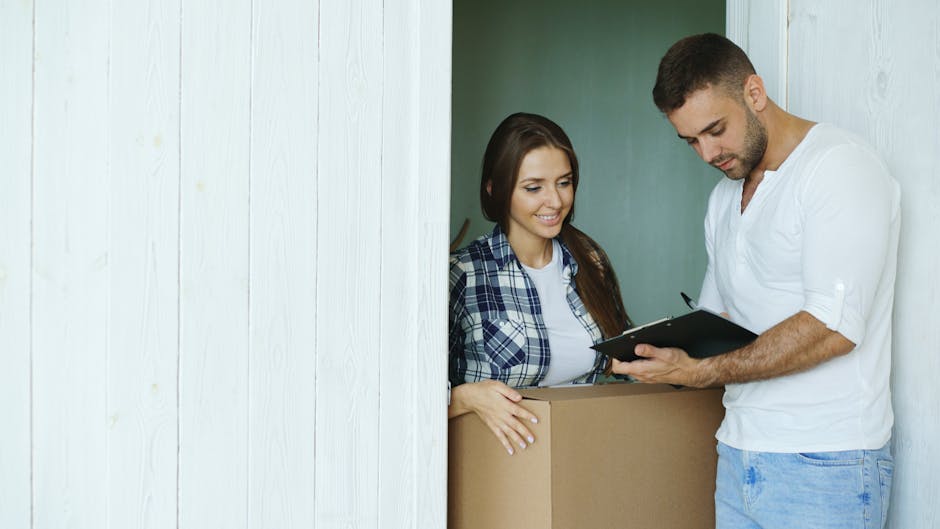 A large collection of various cardboard boxes of different sizes and shapes, some open and some sealed, are stacked and scattered on a light grey concrete floor against a plain white wall. The boxes include cube-shaped, rectangular, and collapsible types, with some placed inside each other or leaning against the wall, indicating a packing or moving process. A few larger boxes are positioned near the wall, while smaller boxes are spread out on the floor, with some stacked on top of others. The environment appears to be an empty room or storage area prepared for home relocation or furniture transport, as associated with house removals services. The scene is well-lit with even lighting, highlighting the materials which primarily consist of plain brown cardboard. This setup suggests the initial stage of packing or loading items for a move, and it reflects the logistical activity involved in furniture transport and packing during relocation, as offered by Man with Van Sydenham Hill.